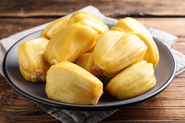 Delicious exotic jackfruit bulbs on wooden table, closeup