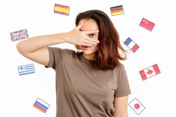 English Language Day. Portrait of a woman covering her face with her hand. White background with...