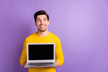 Photo of positive person arms hold netbook showing display look empty space isolated on violet color background