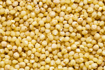 Couscous raw background. Dried couscous seeds closeup flat food texture background. Concept of vegetarianism and healthy eating.
