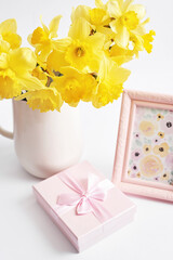 Happy Mothers Day greeting card with flowers. Bouquet of yellow daffodils on white background. Happy Easter template.