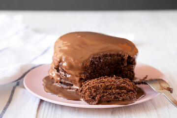 Homemade Chocolate Pancakes on a pink plate, side view.