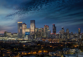 Night view to the illuminated residential and corporate skyscrapers of the financial district Canary Wharf, London, United Kingdom