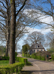 Old traditional farmhouses at dirtroad in the village of Uffelte Drenthe Netherlands. 