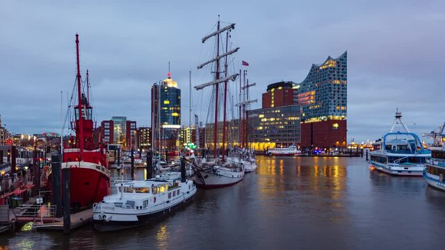 Dusk Time Lapse of of the harbor district, the concert hall "Elbphilharmonie" and ships in foreground, Hamburg, Germany