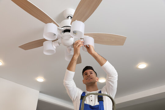 Electrician Changing Light Bulb In, Electrician To Install Ceiling Fan