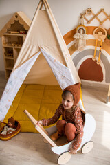 little girl playing in a wigwam in the children's room © Маргарита Медведева