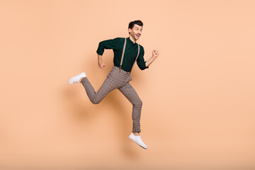 Fototapeta na wymiar Full size profile side photo of young man happy positive smile go walk run jump hurry sale isolated over beige color background