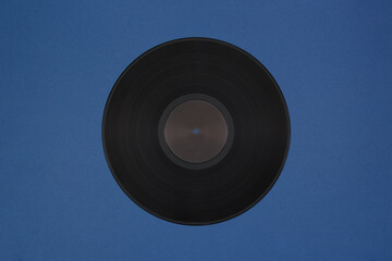 Old black vinyl LP disc. Blue background.