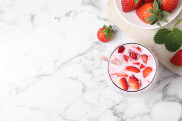 Delicious drink with strawberries on white marble table, flat lay. Space for text