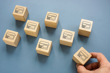 Cubes with shops. Franchise or Merger and Acquisition concept.