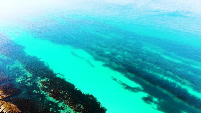 Straight Flying Drone Shot Of Hyams Beach, Flying From The Beache Shoreline Over The Turquoise Ocean