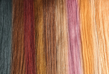 Strands of different color hair as background, closeup