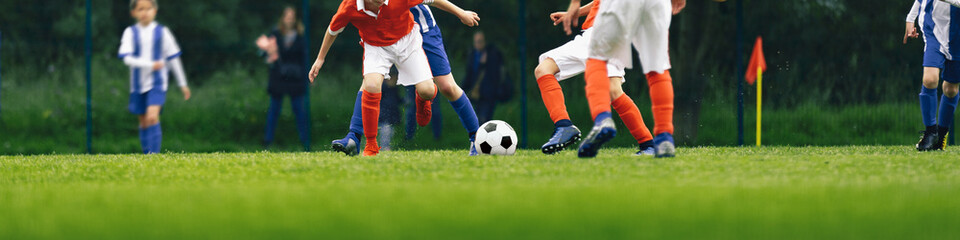 Horizontal Image of Youth Soccer Match. Kids Playing Football Tournament Game. Group of School Boys Running And Kicking Ball on Natural Grass Field