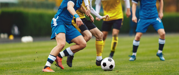 Young Adult Soccer Players Compete at the Pitch. Football League Game. Teenage Sports Players in...