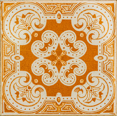 Closeup of traditional vintage ceramic glazed tiles (azulejo) on the walls of Lisbon, Portugal in yellow, orange and brown colors