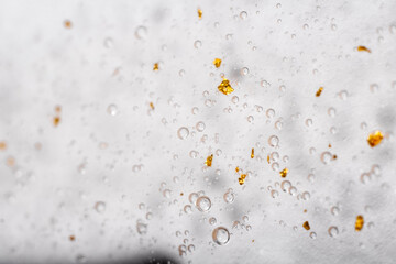 Macro picture of transparent hyaluronic acid with gold. Top horizontal view copyspace. Skin care concept