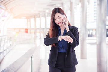 Business woman using smartphone shopping online, call, texting message internet technology lifestyle. Asian woman using cellphone walking on city street. Smart phone smart confident woman modern city