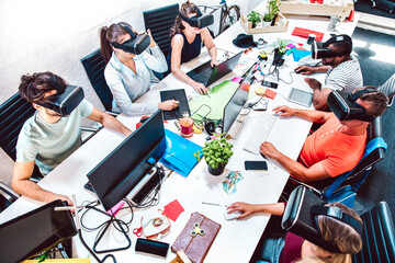 Group of employee workers concentrated on virtual reality goggles at startup studio - Human resources business concept with young people tech team - Start up entrepreneurs at office on bright filter