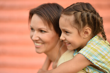 Portrait of happy mother and daughter posing outdoors