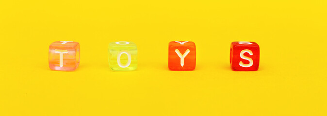 Word toys with colorful cubes of beads on yellow. banner