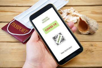 Vaccination passport on a mobile phone allowing travel in hand. Vaccination against the coronavirus Covid 19.Imunity or Health passport