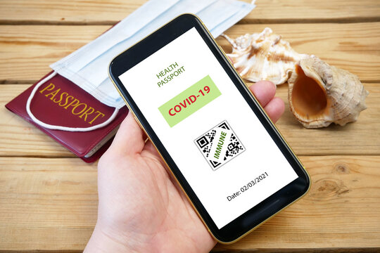 Vaccination passport on a mobile phone allowing travel in hand. Vaccination against the coronavirus Covid 19.Imunity or Health passport