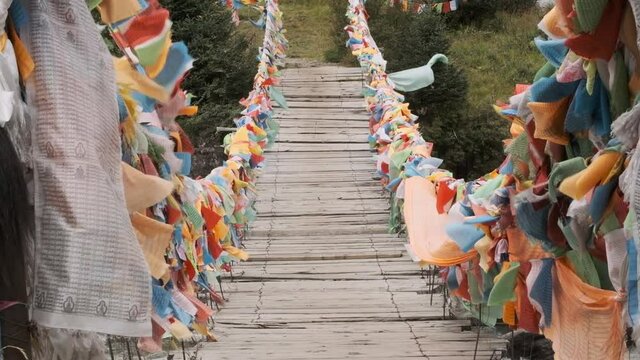 Suspension bridge decorated with piece of fabric of praying flags