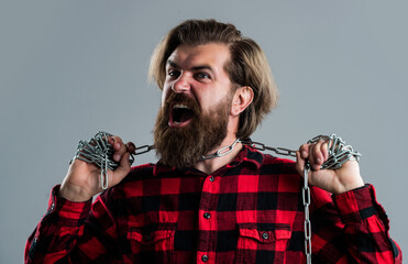 It is so painful. power and strength concept. imprisonment. brutal bearded man in checkered shirt