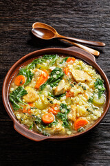 chicken kale veggies soup in a bowl