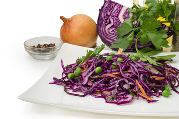 Vegetable salad of chopped red cabbage against ingredients close-up
