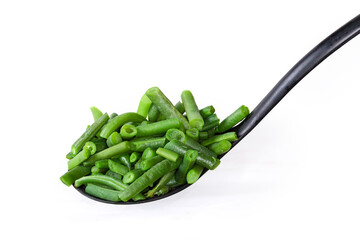 Boiled cut green beans on slotted spoon on white background