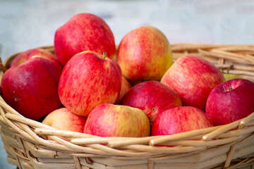 Red ripe apples in a wicker basket