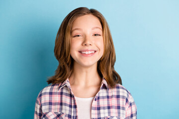 Photo of funny funky small girl wear checkered shirt smiling isolated blue color background