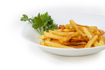 French fries on a white dish with greens close-up