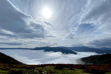 LANDSCAPE WITH HIGH CLOUDS AND FOG IN THE VALLEY