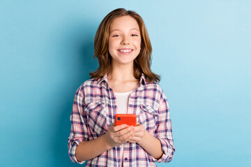 Fototapeta na wymiar Photo of nice optimistic red hairdo girl write telephone wear plaid shirt isolated on blue color background