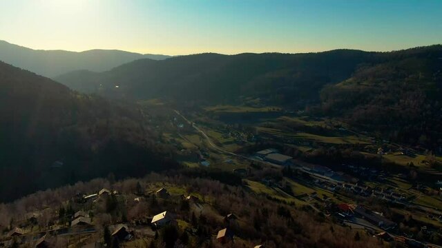 Aerial late evening footage flying over mountains in Bussang France, Vosges region. Forward motion with left turn at end