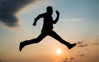 Fototapeta na wymiar total freedom. personal achievement goal. man silhouette jump on sky background. confident businessman running. daily motivation. enjoying life and nature. business success. freedom