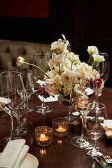 table in the restaurant served for dinner. burning candles and transparent glasses on the table