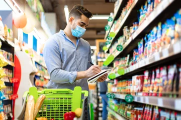 Foto op Plexiglas Arabic Man Taking Notes In Groceries Shopping List In Supermarket © Prostock-studio