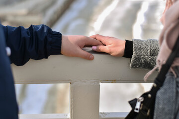 Two people holding hands. A couple in love. Hand in hand. Male and female hand.