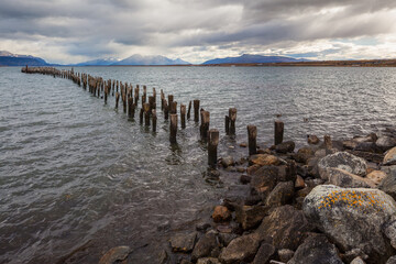 Landscape with fjord and abandoned pier at Puerto Natales in southern Chile