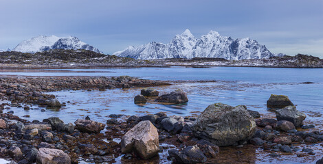 Winter seascape with snow covered mountains and fjord on the Lofoten in northern Norway