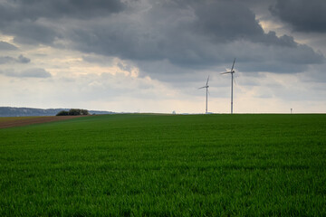Fototapeta na wymiar wind turbine on green field
