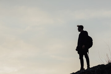 Silhouette of man on top of mountain before  sky with copy space.