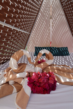 View Of Towels Shaped Into Kissing Birds Heart Inside Of A Beach Cabana At A Luxury Resort In Mexico