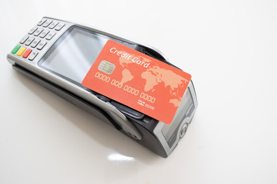 red Credit Card And Pos Terminal On White. High quality photo