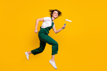 Fototapeta na wymiar Full size profile side photo of happy positive smiling woman painter running fast speed isolated on yellow color background
