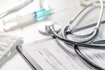 White background doctor office with stethoscope and blue injection